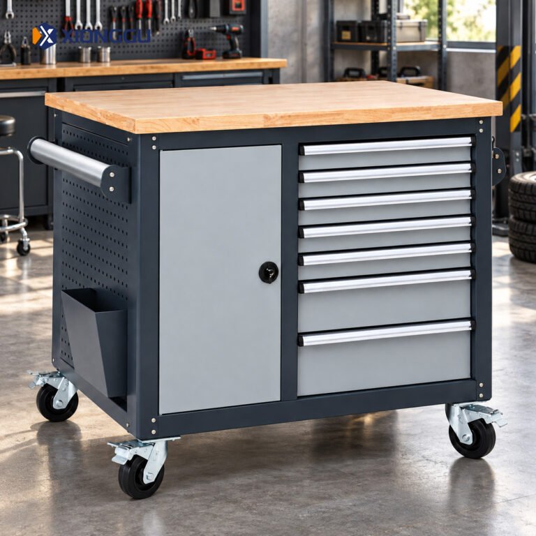 Dark grey tool trolley with silver drawers, open storage shelves, a wooden worktop and caster wheels in a workshop